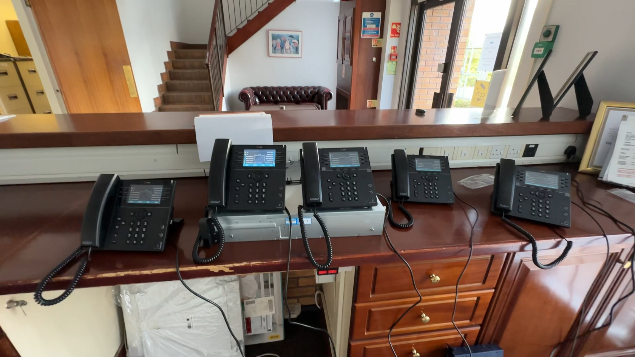 VoIP and Hosted Phone System Installation – Totten IT Solutions Business VoIP phones configured and installed on a reception desk for hosted phone system setup